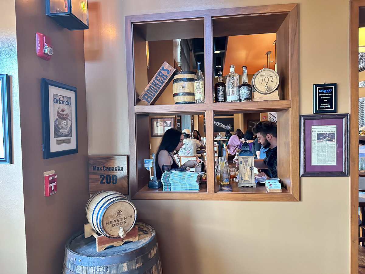 window cutout with whiskey barrel decor